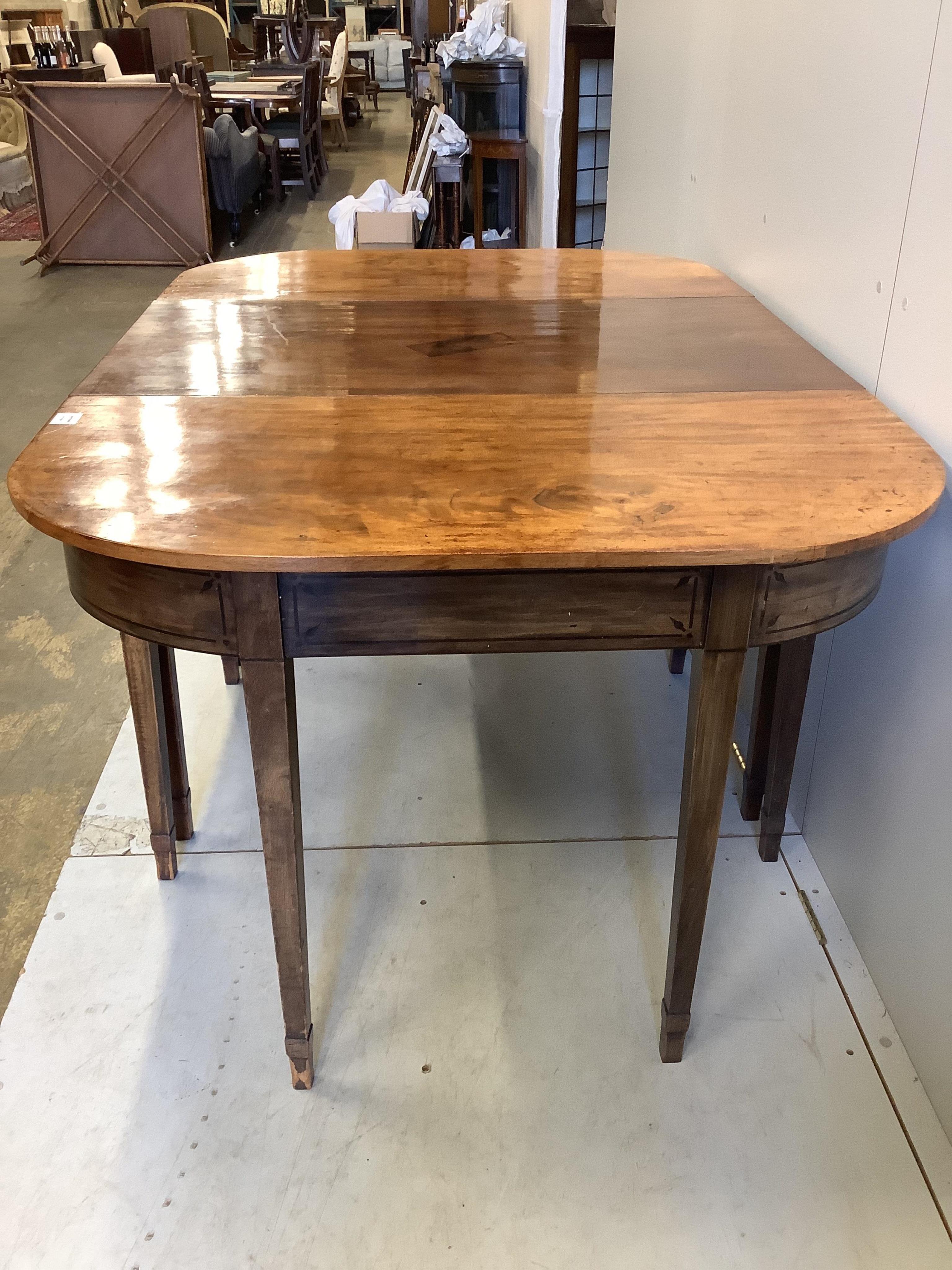 A George III mahogany D end extending dining table, width 162cm, (352cm extended, four spare leaves), depth 107cm, height 76cm. Condition - fair